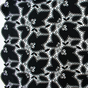 Image of: Sourced from a bridal and evening wear couture house comes this chic designer deadstock guipure lace fabric by the yard - a must have for any fashionista. The design showcases inky black maple leaves surrounded by eyelets and a double scalloped border, while the spaced thread bars (or brides) offer flexibility for incorporating the motif into your project.