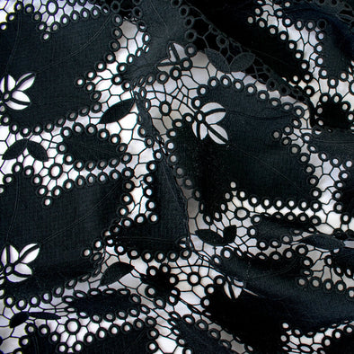 Image of Sourced from a bridal and evening wear couture house comes this chic designer deadstock guipure lace fabric by the yard - a must have for any fashionista. The design showcases inky black maple leaves surrounded by eyelets and a double scalloped border, while the spaced thread bars (or brides) offer flexibility for incorporating the motif into your project.