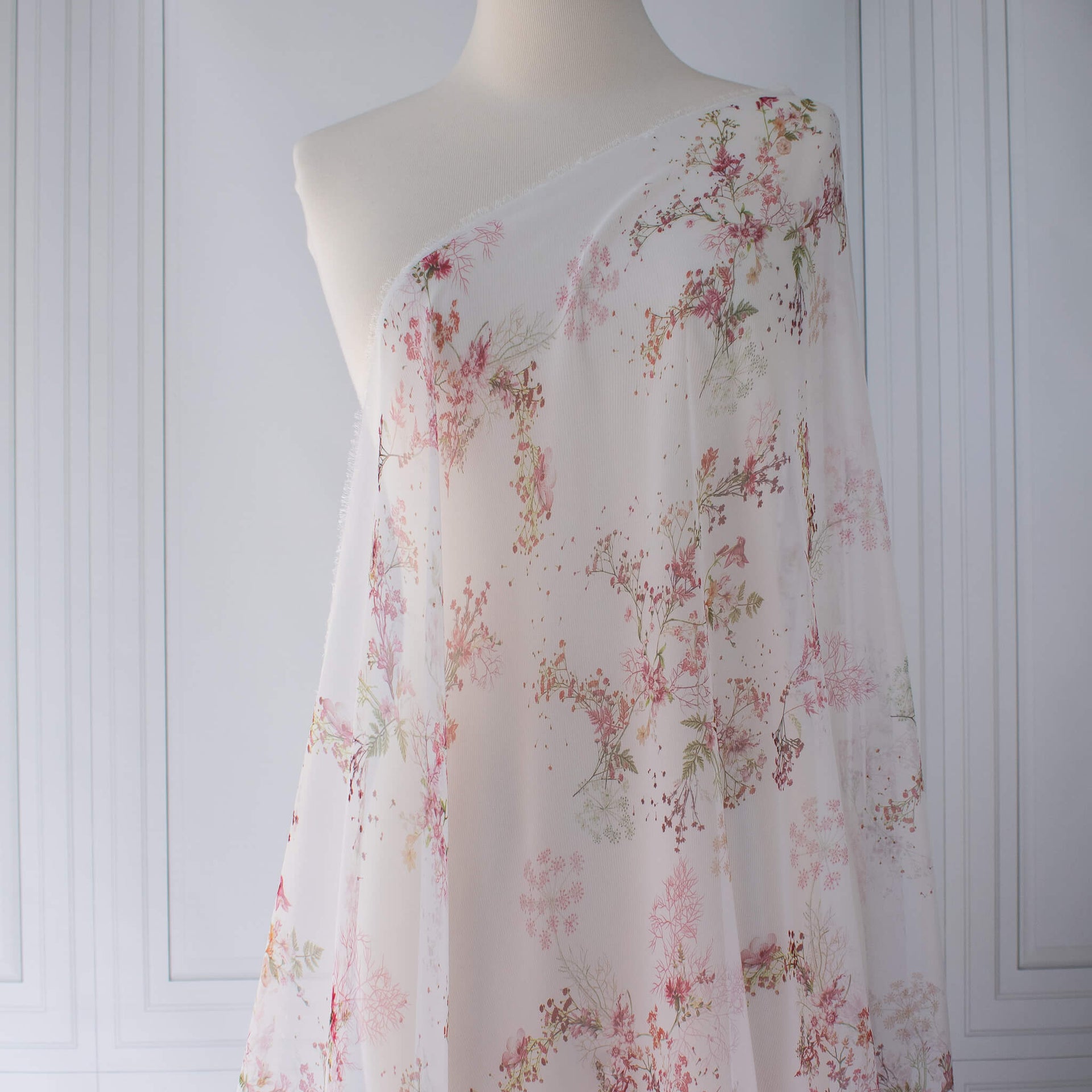 Floral Couture designer soft white silk chiffon fabric with pink flowers and green leaves draped on dressform