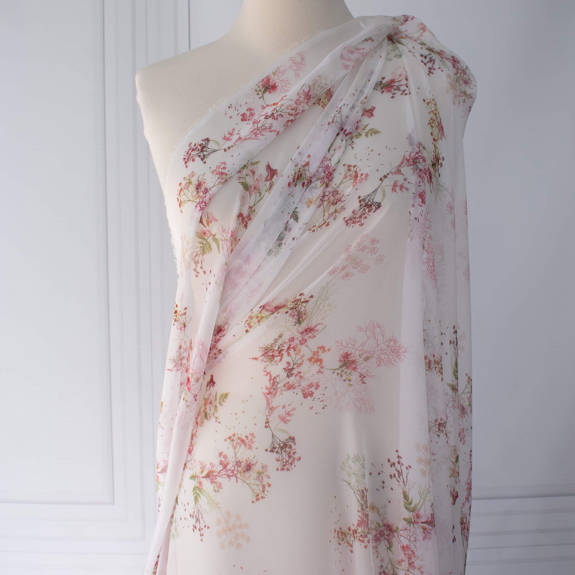 Floral Couture designer soft white silk chiffon fabric with pink flowers and green leaves draped on dressform