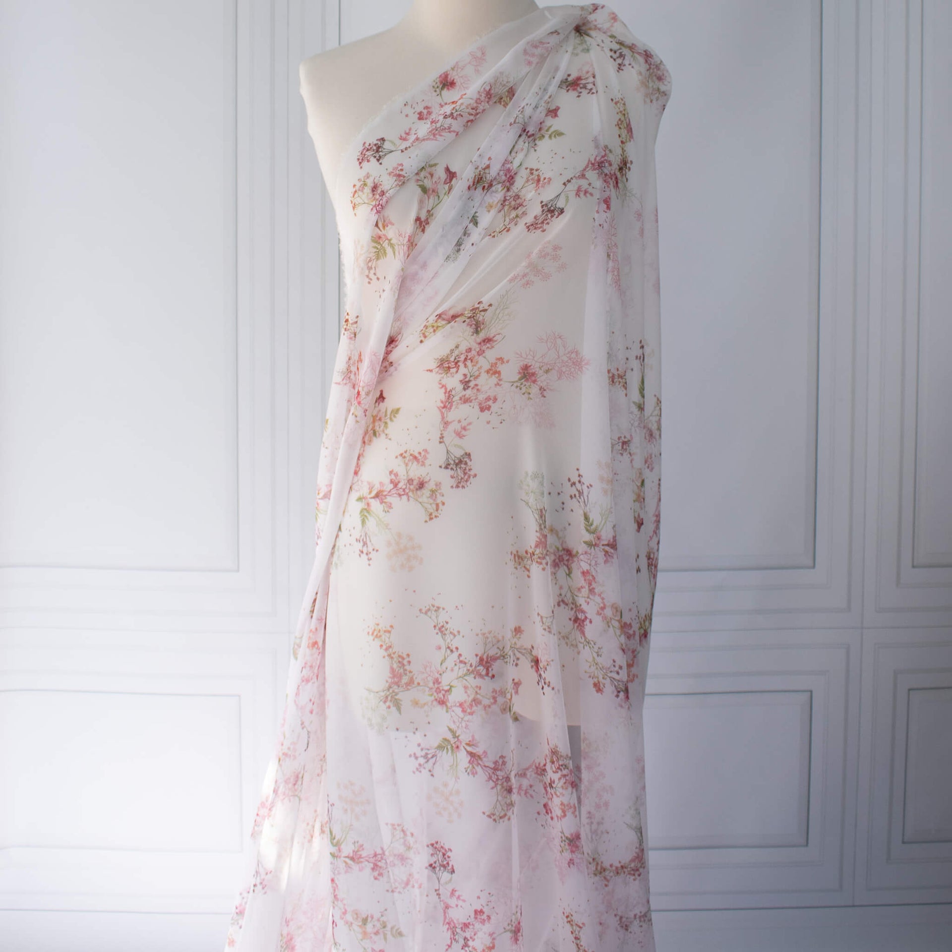 Floral Couture designer soft white silk chiffon fabric with pink flowers and green leaves draped on dressform