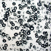 Image of couture black and white floral designer deadstock fabric by the yard! A modern floral design in black set against a creamy white is elevated by the soft "blistered" texture of this stunning jacquard. Perfect for wedding season.