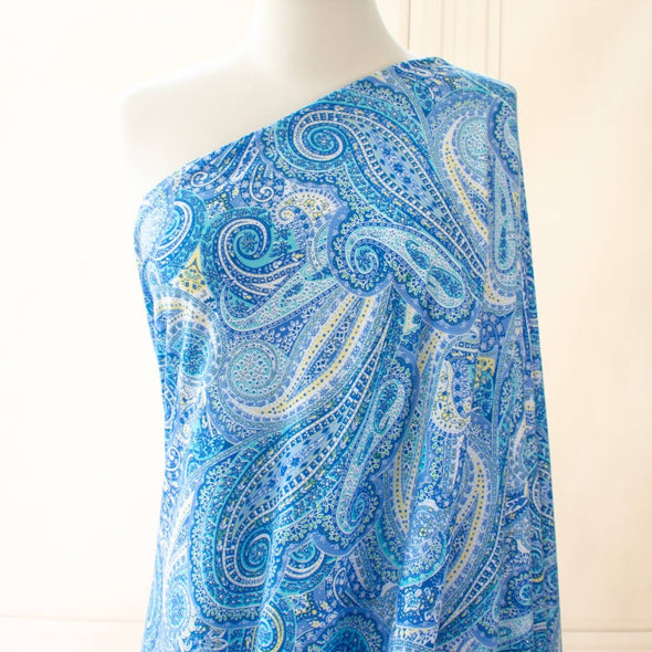 NY Designer Paisley Cotton Jersey fabric is made from 100% cotton for softness and breathability. A designer deadstock fabric that will keep you feeling comfortable and luxuriously stylish all day.  Image of fabric draped on dressform.