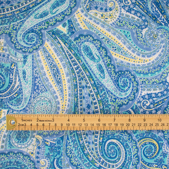 NY Designer Paisley Cotton Jersey fabric is made from 100% cotton for softness and breathability. A designer deadstock fabric that will keep you feeling comfortable and luxuriously stylish all day.  Image of fabric with ruler for pattern scale.