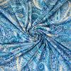 NY Designer Paisley Cotton Jersey fabric is made from 100% cotton for softness and breathability. A designer deadstock fabric that will keep you feeling comfortable and luxuriously stylish all day.  Image of fabric swirled  to demonstrate body.