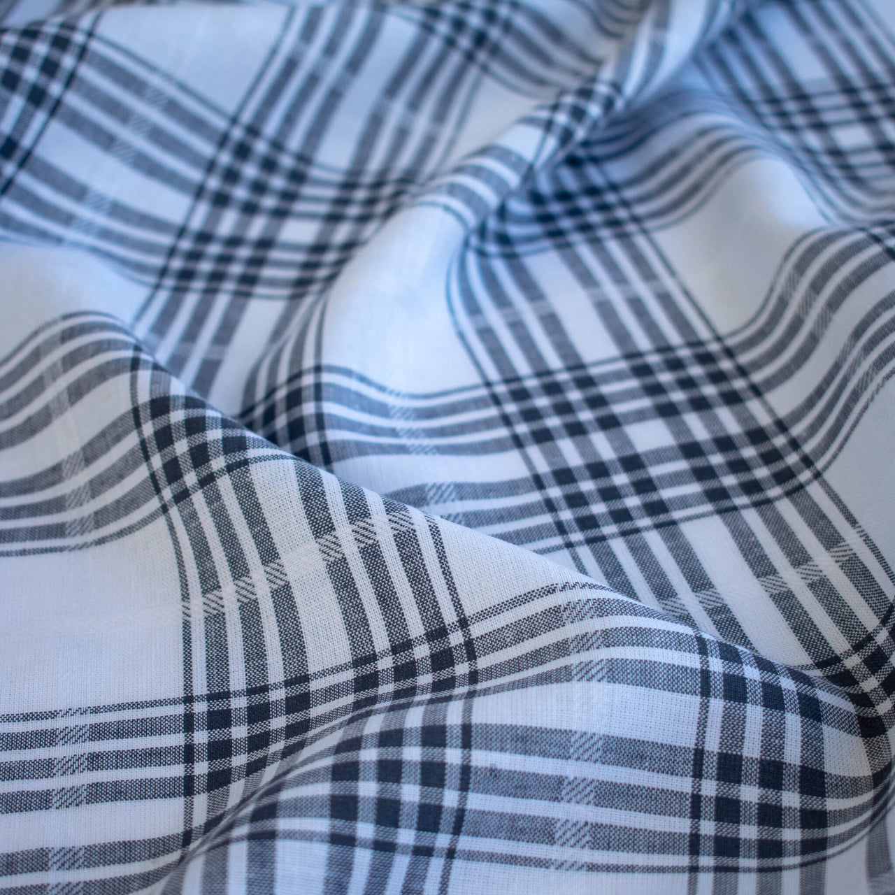 Close-up of designer cotton gauze plaid fabric 