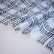 Plaid cotton gauze fabric with blue and white stripes on a light background