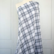 Plaid cotton gauze fabric draped over a mannequin on a white background
