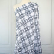 Plaid cotton gauze fabric draped over a mannequin on a white background