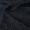Create your own luxurious streetwear with this High End Designer deadstock denim fabric by the yard. 100% Cotton dark wash blue denim is robust with a textured stiff hand yet it still has some drape and a softness that feels good against the skin. Close up image of fabric.