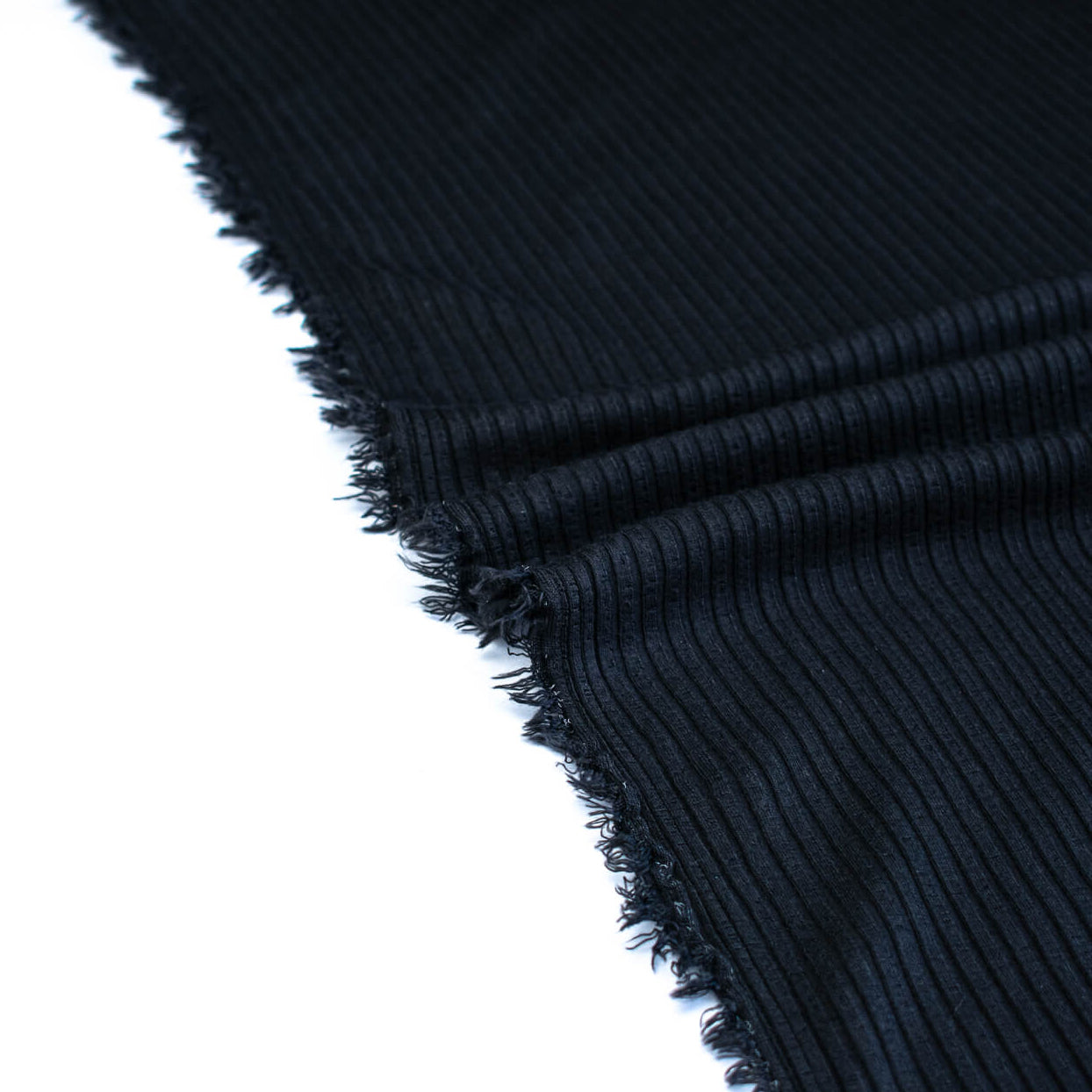 Close-up of selvedge NYC Designer Black Rayon Rib Knit fabric by the yard.