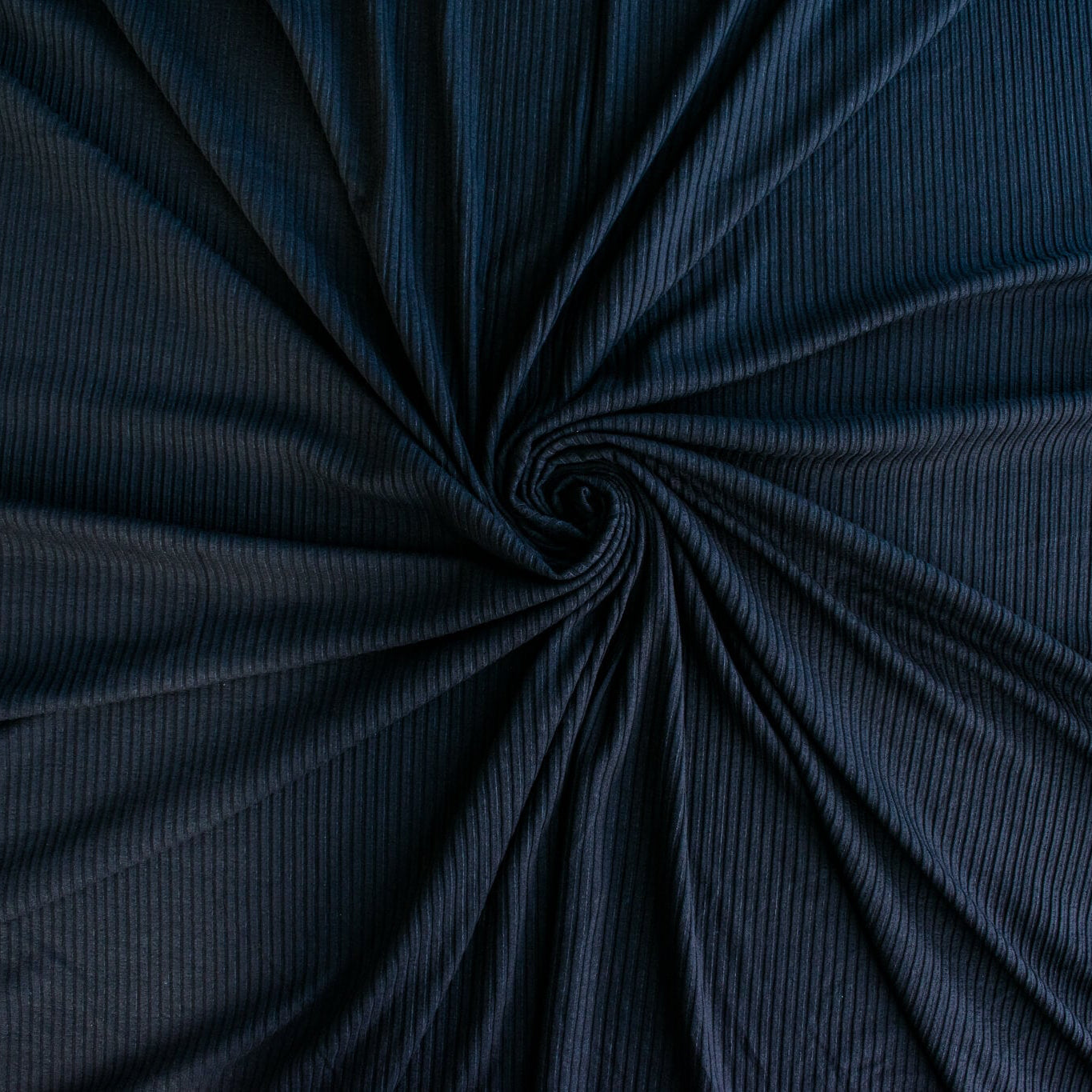 Image of NYC Designer Black Rayon Rib Knit fabric twirled to demonstrate fullness.
