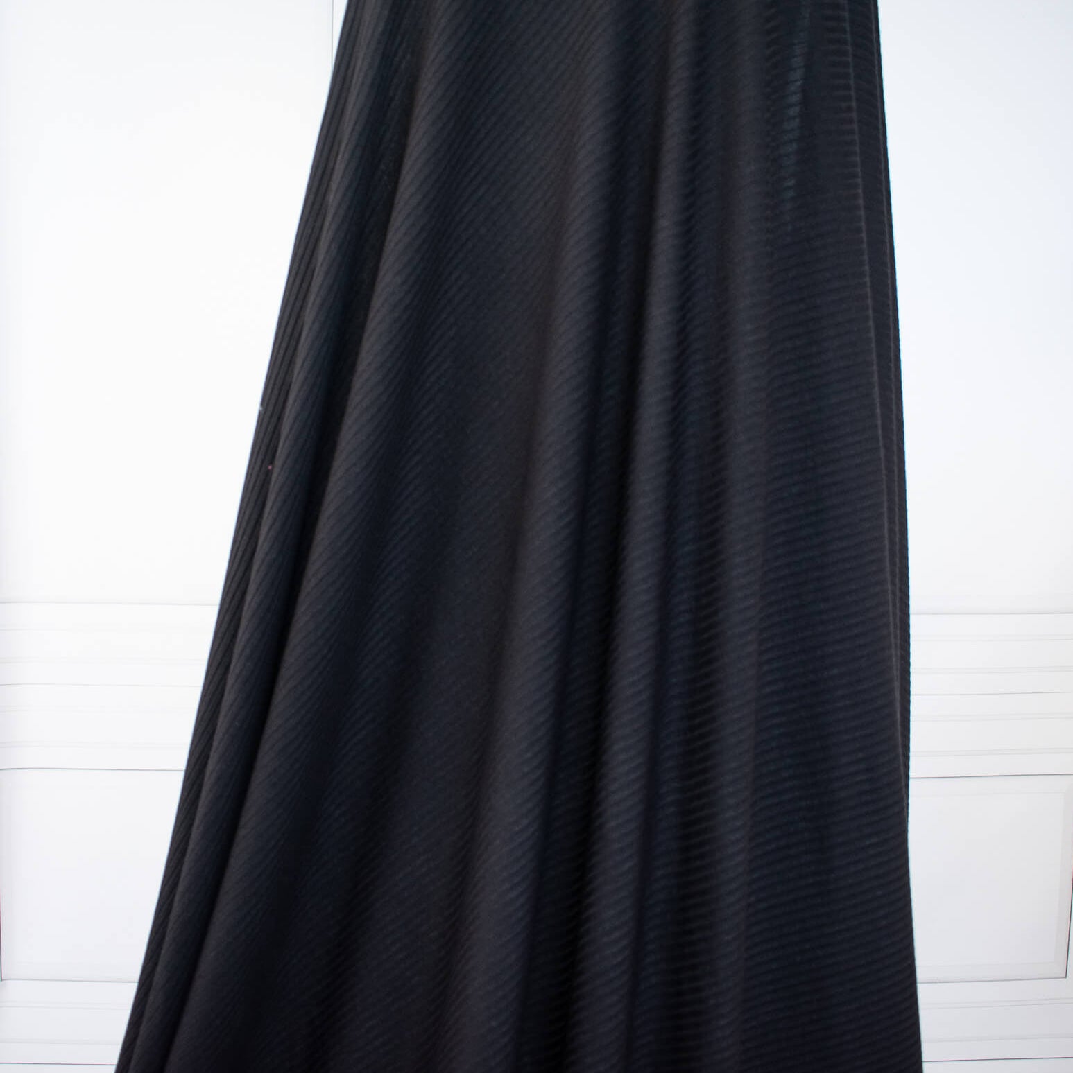 Image of NYC Designer Black Rayon Rib Knit fabric draped on dress form.