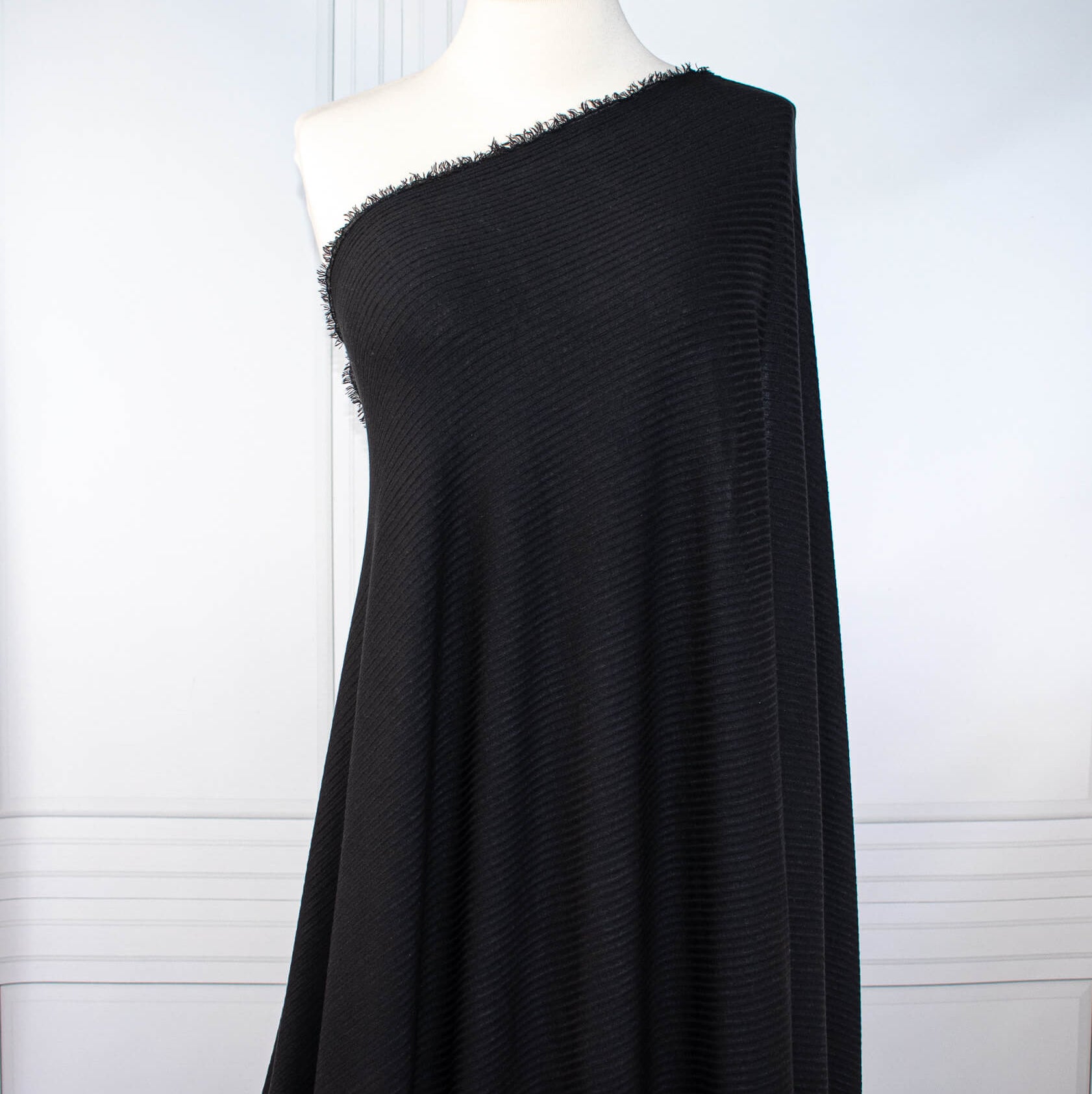 Image of NYC Designer Black Rayon Rib Knit fabric draped on dress form.