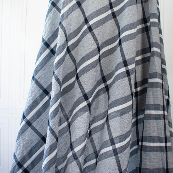 modern, navy blue and white plaid high-end designer cotton fabric. Photo of fabric draped on dressform.