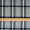 modern, navy blue and white plaid high-end designer cotton fabric. Photo of fabric with ruler to show pattern scale.