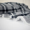 modern, navy blue and white plaid high-end designer cotton fabric. Close up photo of selvedge.