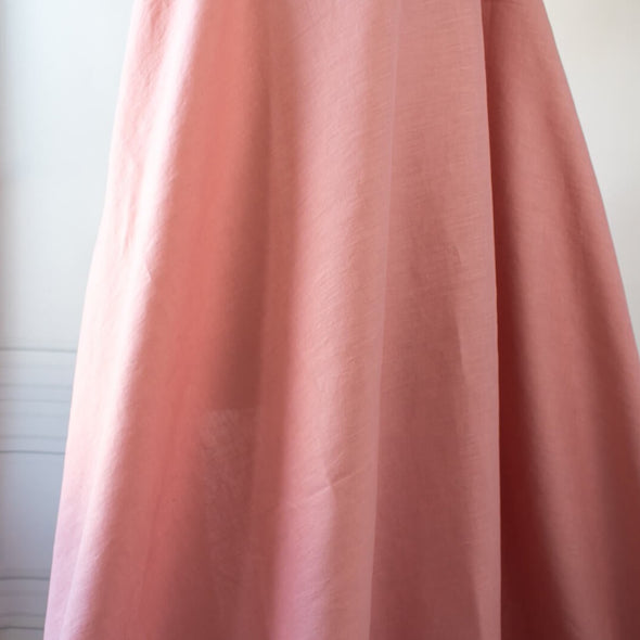 Enjoy the comfortable and luxurious feel of this designer 100% Linen fabric by the yard. This fine fabric features a classy soft rose color and is sure to inspire your 'Me Made' projects.  Image of fabric drape.