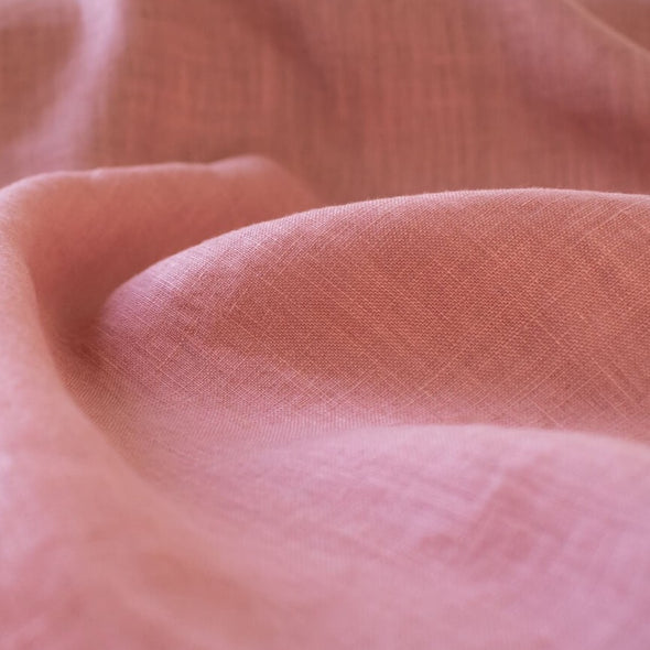 Enjoy the comfortable and luxurious feel of this designer 100% Linen fabric by the yard. This fine fabric features a classy soft rose color and is sure to inspire your 'Me Made' projects.  Close up photo.