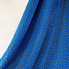 Designer Blue paisley Italian satin challis with a fluid drape and satiny softness from the Parisian luxury designer M@je. Image of fabric drape.