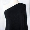 Feel glamorous with our Designer Shimmer Black Sweater Knit fabric by the yard - 'Fancy This'. This high-end designer deadstock knit in classic black with the perfect touch of sparkle. Soft and comfortable, this sweater is sure to become one of your favorite fashion staples. Image of fabric on dressform