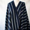 Deveaux France luxury yarn-dyed woven striped fabric featuring a crepe like texture and soft drape. Fabric with white and cobalt blue vertical stripes. Image of fabric draped on dressrform.