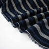 Deveaux France luxury yarn-dyed woven striped fabric featuring a crepe like texture and soft drape close up picture of fabric selvedge with white and cobalt blue vertical stripes.