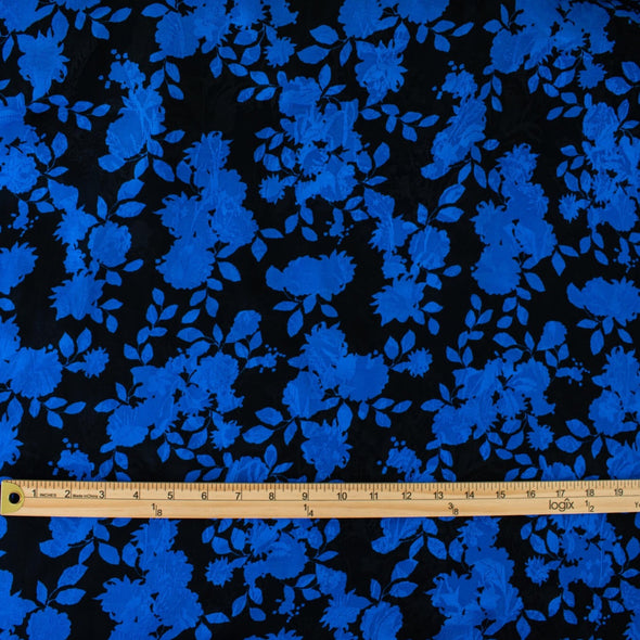 The 'Roses in Blue' Italian Jacquard fabric by the yard is just gorgeous! Luxurious and elegant, a beautiful black viscose fabric featuring a vibrant blue floral design that is sure to get you noticed.  Opaque with a nice drape and body, it is perfect for formal attire or a little something special. Image of fabric with ruler for scale.