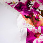 Image of designer Italian satin viscose woven fabric by the yard. Featuring an exquisite watercolor floral pattern of dark pink abstract roses against a soft white background.
