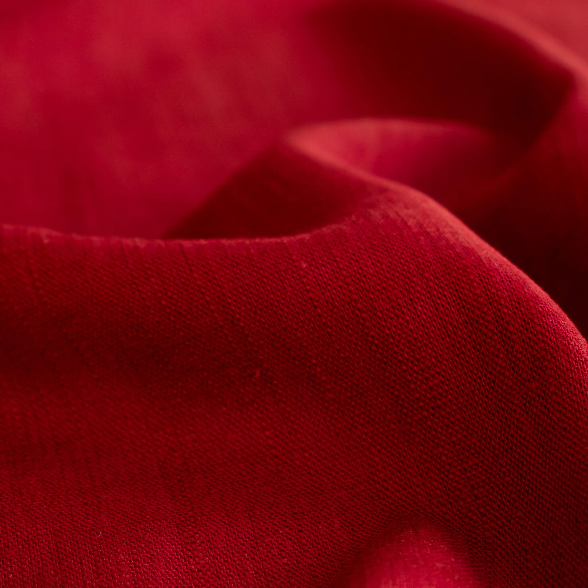 Close up image of Premium Italian linen-viscose blend in a rich burnt carmine hue.