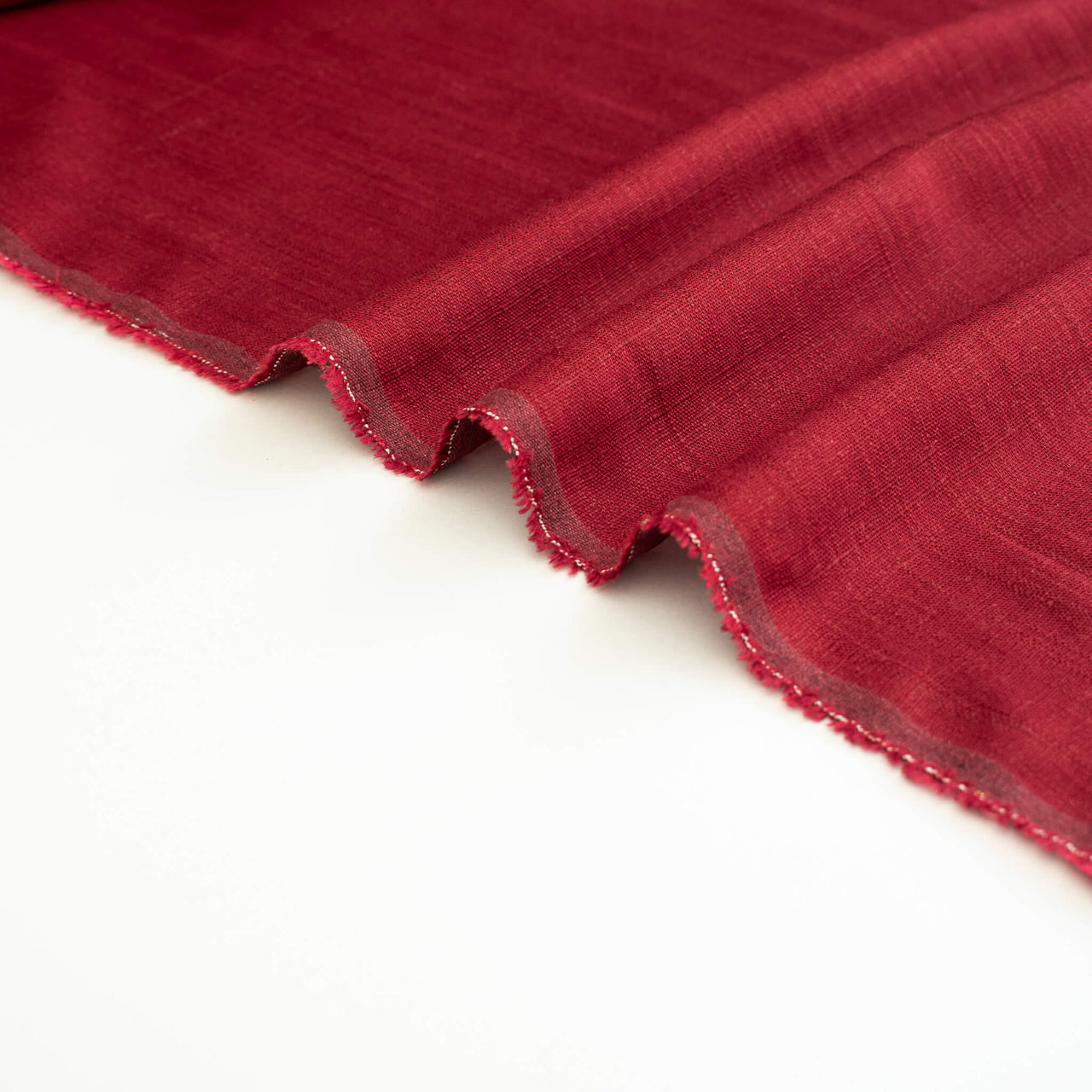 Image of Premium Italian linen-viscose blend in a rich burnt carmine hue. (selvedge)