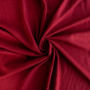 Premium Italian linen-viscose blend in a rich burnt carmine hue. Fabric shown to demonstrate fullness.