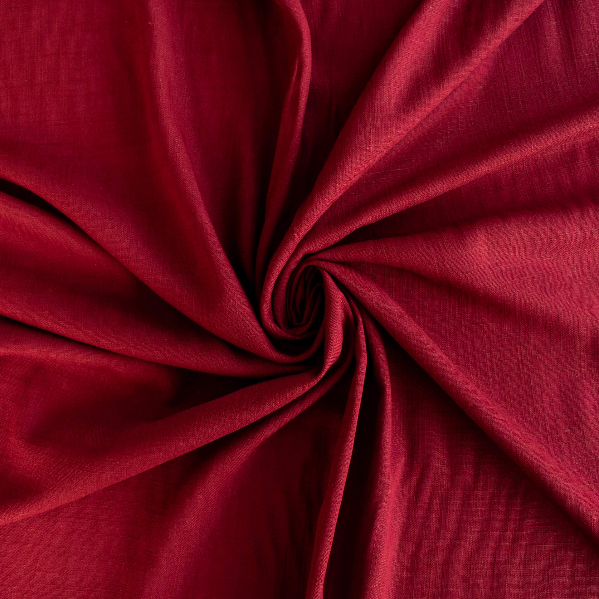 Premium Italian linen-viscose blend in a rich burnt carmine hue. Fabric shown to demonstrate fullness.