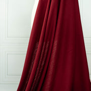 Premium Italian linen-viscose blend in a rich burnt carmine hue. Image of fabric drape.