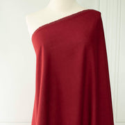 Premium Italian linen-viscose blend in a rich burnt carmine hue on dressform.