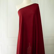 Premium Italian linen-viscose blend in a rich burnt carmine hue on dressform.