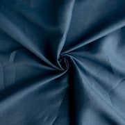 A close-up of Image of Italian linen and viscose blend woven fabric by the yard in a soft Aegean blue arranged in a spiral swirl, showing its soft texture, fullness, and subtle sheen.