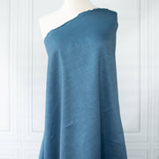 Image of Italian linen and viscose blend woven fabric by the yard in a soft Aegean blue draped on dress form.
