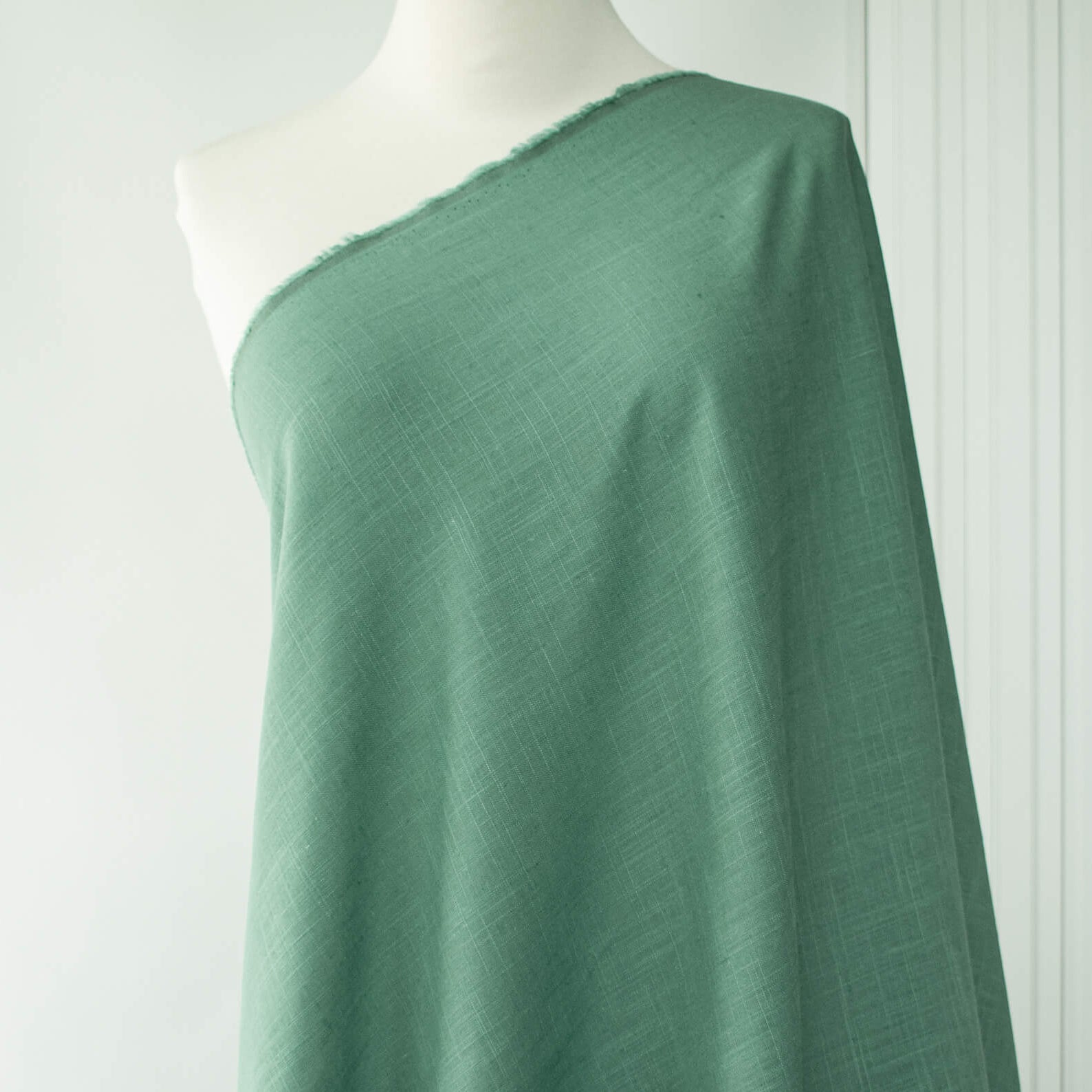 Image of Fine Italian light turquoise linen-viscose blend fabric on dressform.