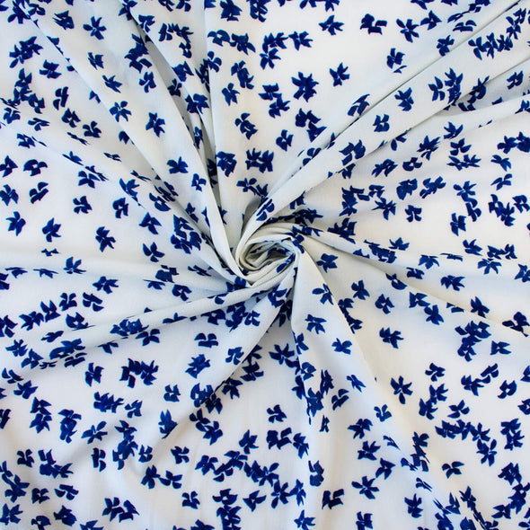 Image of fabric body. Couture, Italian, blue and white floral crepe deadstock fabric by the yard. Sourced from a Los Angeles designer of ready-to-wear and bridal pieces and a favorite among some of Hollywoods A-List stars! 