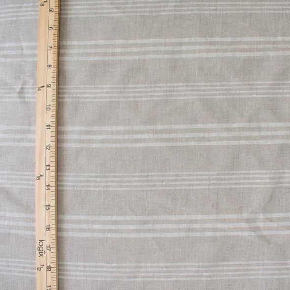 Experience the luxury of European linen fabric in a classic horizontal stripe. This medium weight linen would make a stunning jacket, skirt or pant. Featuring a wide width, textured hand, and sets of wide and narrow off white stripes. Photo of fabric with ruler to show pattern scale.