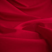 Close up image of A gorgeous Red Ponte di Roma double knit fabric by the yard has a soft hand and full bodied drape. You'll love the feel of this Ponte an it is perfect for dresses, jackets and more!