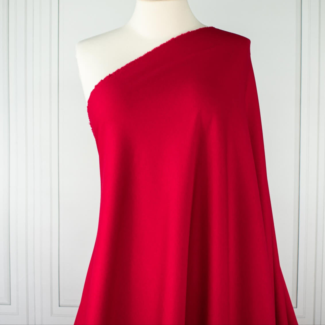 Image of fabric draped on dressform. A gorgeous Red Ponte di Roma double knit fabric by the yard has a soft hand and full bodied drape. You'll love the feel of this Ponte an it is perfect for dresses, jackets and more!
