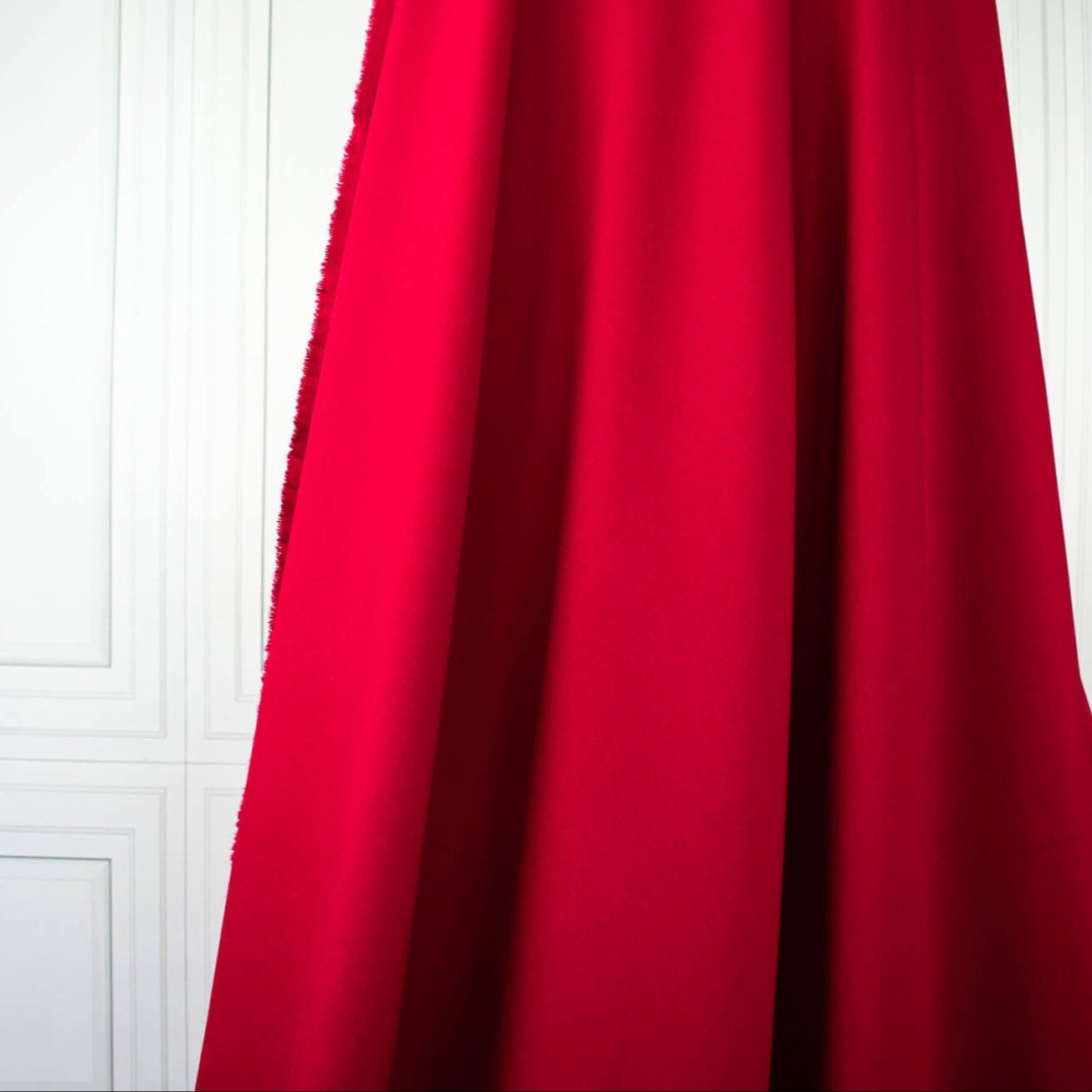 Image of fabric drape. A gorgeous Red Ponte di Roma double knit fabric by the yard has a soft hand and full bodied drape. You'll love the feel of this Ponte an it is perfect for dresses, jackets and more!