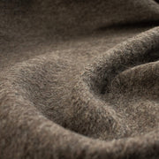 Italian Couture Wool Single Faced designer deadstock knit fabric by the yard in dark taupe and white. Perfect for chilly days this wool knit mimics a fleece with a fuzzy texture on the face and a lightly textured back. Close up image.