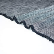 Close-up of blue and white cotton slub fabric and selvedge.
