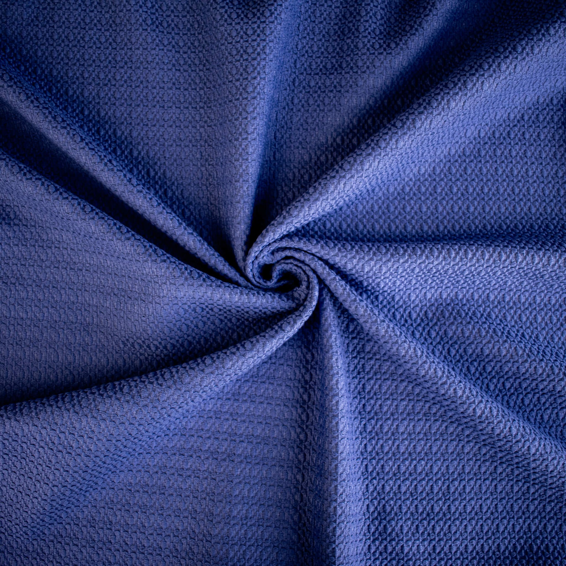 Violet  textured couture designer fabric swirled to demonstrate fabric body.
