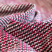 Close-up of a red, white, Couture designer fabric.