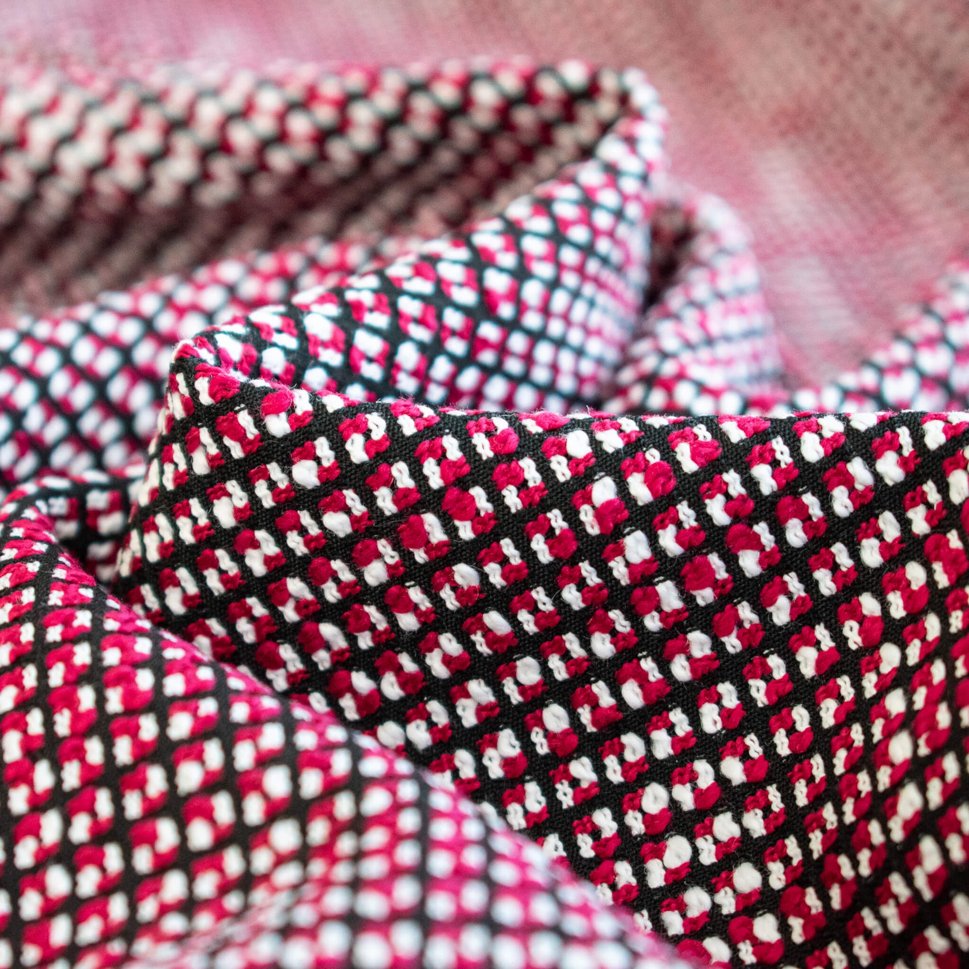 Close-up of a red, white, Couture designer fabric.