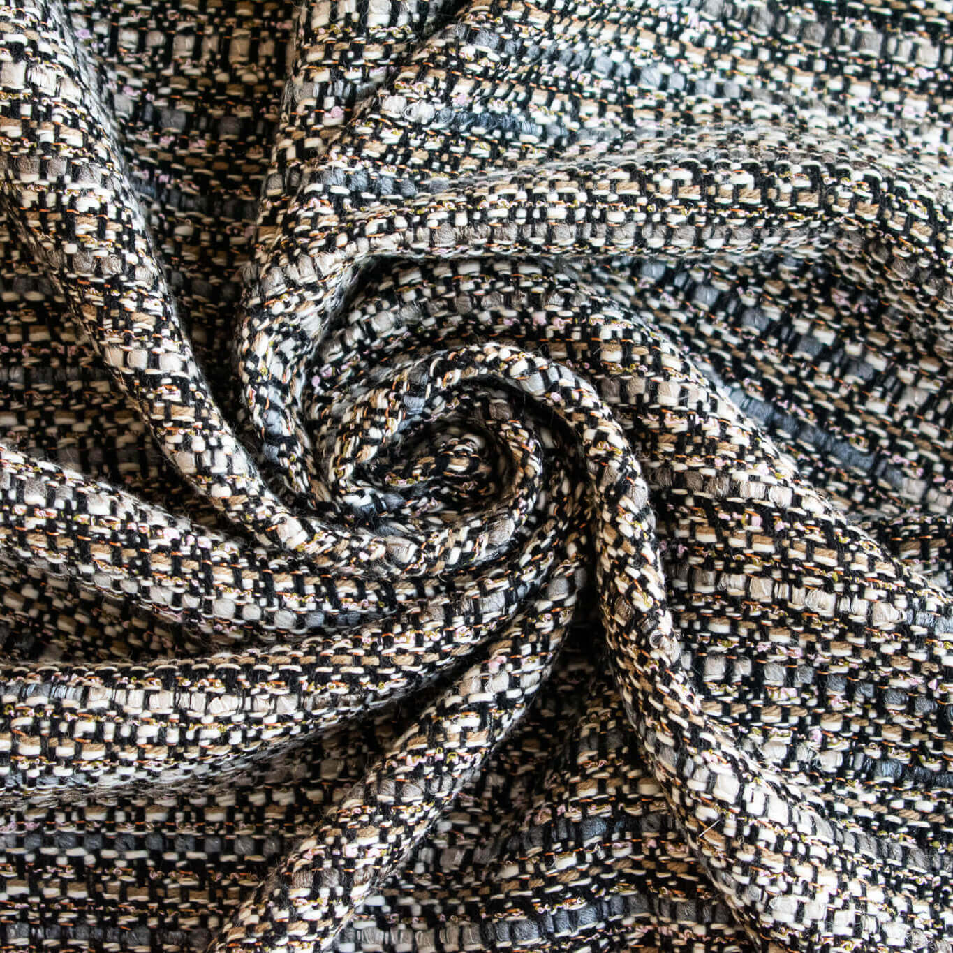 Close-up of tCouture Designer Italian Wool Boucle fabric with a swirling pattern